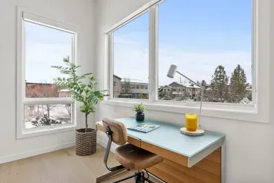 Sunny corner workspace with large windows and peaceful neighborhood views