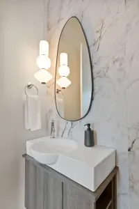 Modern marble bathroom with designer lighting and sleek vanity
