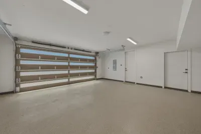 Spacious finished garage with modern lighting and natural light