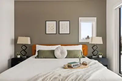 Bright, stylish bedroom with plush king bed and serene natural light