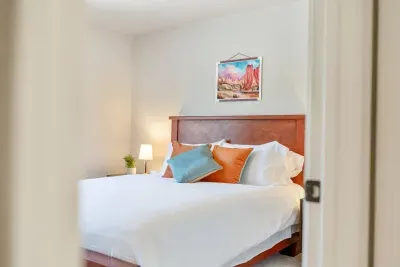 The third bedroom also has a new queen memory foam mattress atop a beautiful wood bedframe with nearby closet, hamper, and luggage rack.