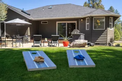 This large, flat grassy space is perfect for a cornhole match