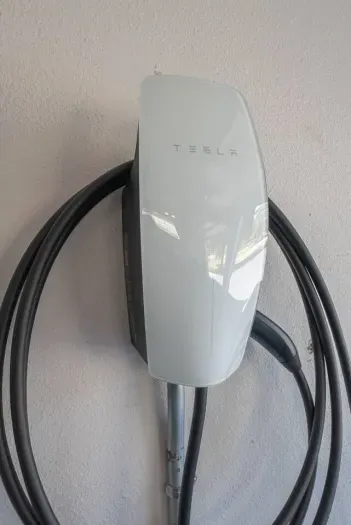 Telsa EV charger with universal adapter; use the app to pay per charge