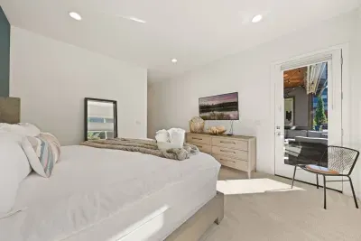 Bedroom 1: Downstairs King Suite - large room with Temper-Pedic king mattress, smartTV, door to patio, private bathroom + linen closet to store belongings. Bedrooms come with privacy shades, all bed linens and pillows, and extra blankets and pillows.