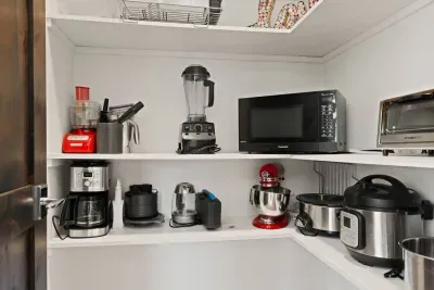 Pantry off of kitchen with small appliances and plenty of space to store food!