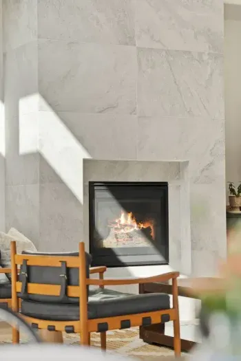 The living room is large with soaring ceilings, gas insert fireplace, smart TV with access to your apps, games, books, game console, free internet, a large sectional sofa with stylish chairs, coffee table, and open to the dining and kitchen areas