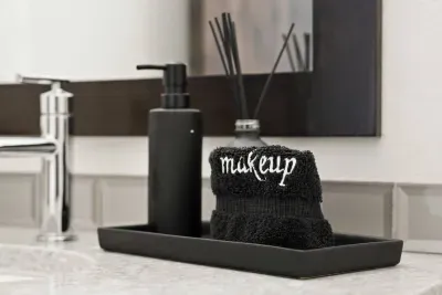 Bathroom 4: Half bathroom (powder room) located downstairs off the main foyer. Includes single vanity sink and toilet. Bathrooms come with towels, hand soap, and jar of hair ties and cotton balls.