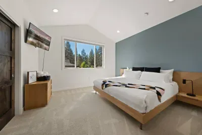 Bedroom 2: Upstairs King Suite - gorgeous treed view, king mattress, smartTV, private bathroom + closet to store belongings. Bedrooms come with privacy shades, all bed linens and pillows, and extra blankets and pillows.