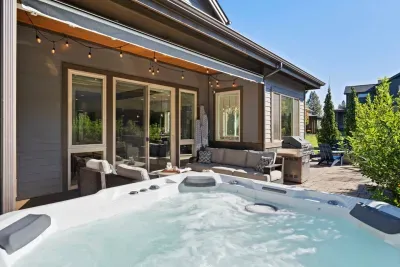 Patio: Large salt water hot tub (professionally cleaned and maintained between each stay), propane firepit, comfortable outdoor seating, BBQ, cafe lights. Please note this is an unfenced patio. Opens to large grassy yard.