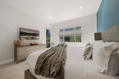 Bedroom 1: Downstairs King Suite - large room with Temper-Pedic king mattress, smartTV, door to patio, private bathroom + linen closet to store belongings. Bedrooms come with privacy shades, all bed linens and pillows, and extra blankets and pillows.