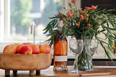 Full kitchen with quartz countertops, open to living and dining areas, island seating for 5. Kitchen is stocked with coffee, coffee maker (drip), basic seasonings, pots, pans, serveware, dishes, utensils, and kitchen appliances small and large!