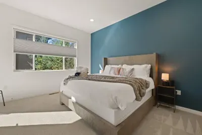 Bedroom 1: Downstairs King Suite - large room with Temper-Pedic king mattress, smartTV, door to patio, private bathroom + linen closet to store belongings. Bedrooms come with privacy shades, all bed linens and pillows, and extra blankets and pillows.