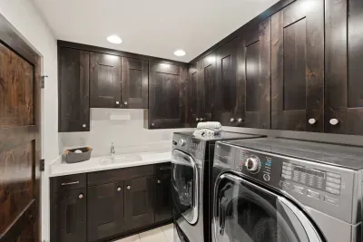 Laundry room is off of downstairs hallway and connects to the two car garage. Large front load washer (with pedestal washer underneath!) and dryer available for guest use. Detergent, steamer, iron, dryer balls available for guest use.