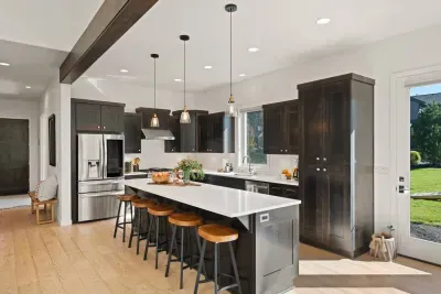 Full kitchen with quartz countertops, open to living and dining areas, island seating for 5. Kitchen is stocked with coffee, coffee maker (drip), basic seasonings, pots, pans, serveware, dishes, utensils, and kitchen appliances small and large!