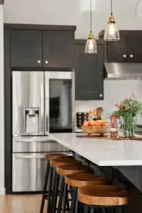 Full kitchen with quartz countertops, open to living and dining areas, island seating for 5. Kitchen is stocked with coffee, coffee maker (drip), basic seasonings, pots, pans, serveware, dishes, utensils, and kitchen appliances small and large!