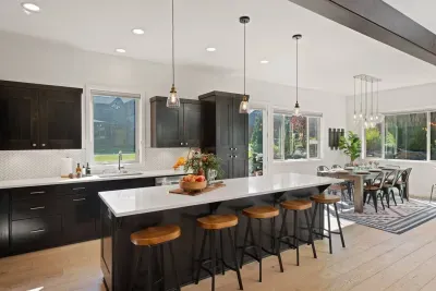 Full kitchen with quartz countertops, open to living and dining areas, island seating for 5. Kitchen is stocked with coffee, coffee maker (drip), basic seasonings, pots, pans, serveware, dishes, utensils, and kitchen appliances small and large!