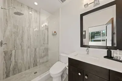 Bathroom 2: Private ensuite bathroom to upstairs king bedroom. Includes walk in shower, bidet toilet, single sink vanity. Bathrooms come with soaps (hair, body, hand), hair dryer, towels and bathmats.