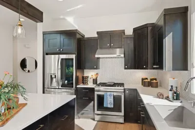 Full kitchen with quartz countertops, open to living and dining areas, island seating for 5. Kitchen is stocked with coffee, coffee maker (drip), basic seasonings, pots, pans, serveware, dishes, utensils, and kitchen appliances small and large!