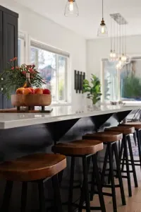 Full kitchen with quartz countertops, open to living and dining areas, island seating for 5. Kitchen is stocked with coffee, coffee maker (drip), basic seasonings, pots, pans, serveware, dishes, utensils, and kitchen appliances small and large!