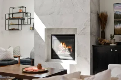 The living room is large with soaring ceilings, gas insert fireplace, smart TV with access to your apps, games, books, game console, free internet, a large sectional sofa with stylish chairs, coffee table, and open to the dining and kitchen areas