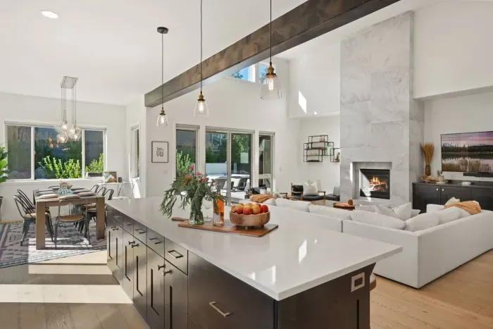 Full kitchen with quartz countertops, open to living and dining areas, island seating for 5. Kitchen is stocked with coffee, coffee maker (drip), basic seasonings, pots, pans, serveware, dishes, utensils, and kitchen appliances small and large!