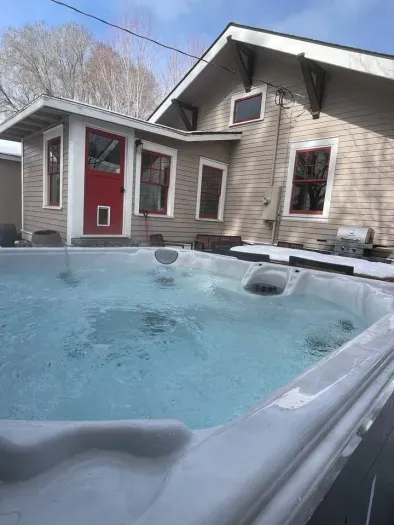 New 6 person salt water hot tub added in 2024 and is professionally cleaned between guests. It overlooks the lush and private backyard.