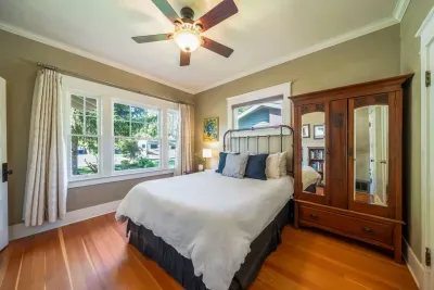 The front bedroom has a queen bed with new memory foam mattress by Tuft and Needle, a bookcase with books and games, and a closet that houses and extra rollaway twin bed for an extra guest (small adult or child)