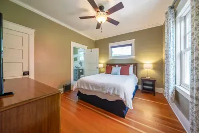 This is a bedroom at the back of the home that has a queen bed with new Tuft & Needle memory mattress, a TV with cable, dresser, and closet with an extra rollaway twin bed for that extra guest (small adult or child).