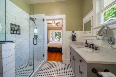 This full bathroom was recently remodeled and offers towels, soaps, paper goods, and a first aid kit. It sits between the two bedrooms of the home.