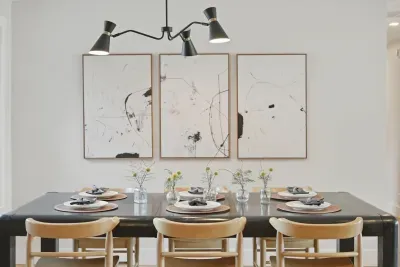 Modern dining for six with chic lighting and curated art