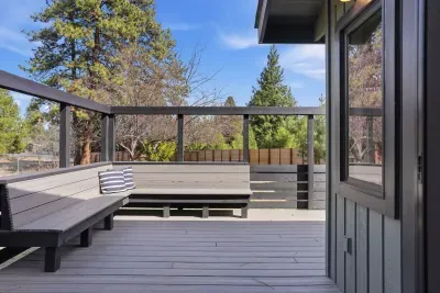 Spacious deck with built-in seating and pine views—perfect for relaxing