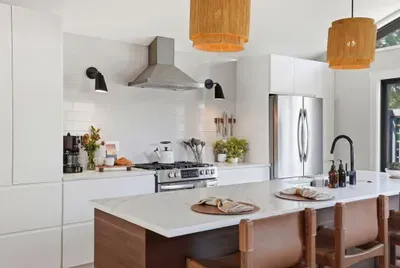 Stylish chef’s kitchen: quartz island, gas range, coffee bar & seating.