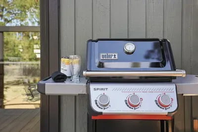 Modern gas grill on the deck—perfect for cookouts under the pines