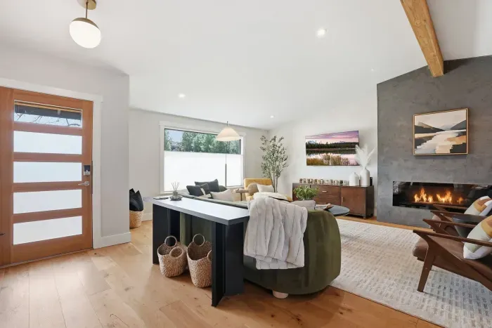 Bright, modern lounge with gas fireplace, wood accents & cozy seating.