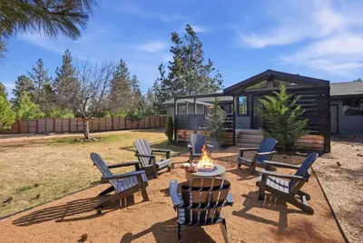 Spacious fenced yard with fire pit lounge at modern cabin retreat