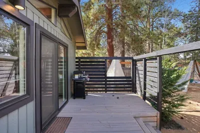 Modern deck with forest views and family-friendly yard amenities