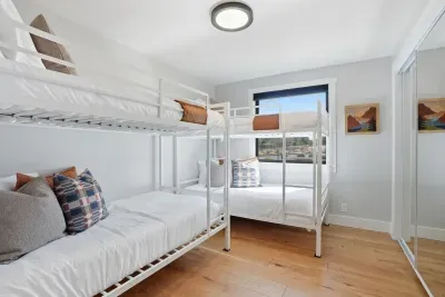 Bright bunk room sleeps 4 with window views & mirrored closet