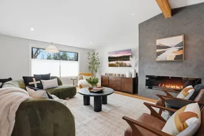 Bright lounge with sleek fireplace, vaulted ceiling & chic seating