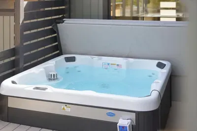 Private deck hot tub with massaging jets and privacy screen—unwind.