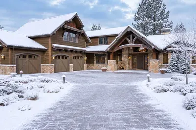 Snowy luxury lodge with grand entry and stunning mountain charm