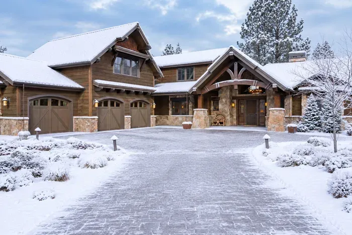 Snowy luxury lodge with grand entry and stunning mountain charm