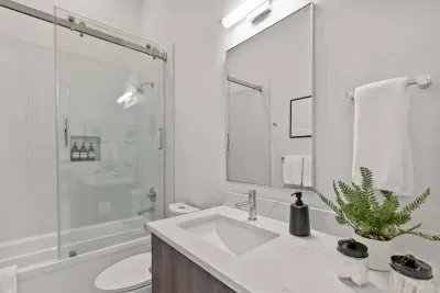 Full bathroom 2: shared between the second king bedroom and queen bunk room, this bathroom lives large with lofted ceilings, modern and clean finishes, and custom glass paneled shower/tub combo. Linens and soaps included with your stay.