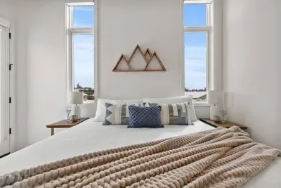 Second bedroom with large king bed and private balcony and closet. This room shares a full bathroom with the queen bunk room.