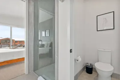Primary bathroom: Luxury is the best way to describe this room. Curbless, walk-in shower framed with custom glass, heated floors throughout, dual sink and smart mirror with settings for daylight, makeup, or natural lighting, and private toilet room