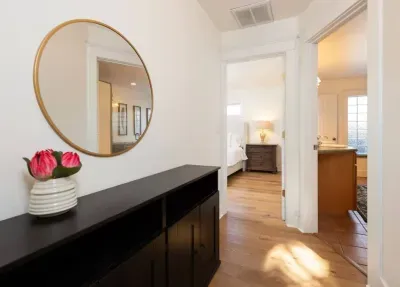 Hallway in main home to primary shared bath