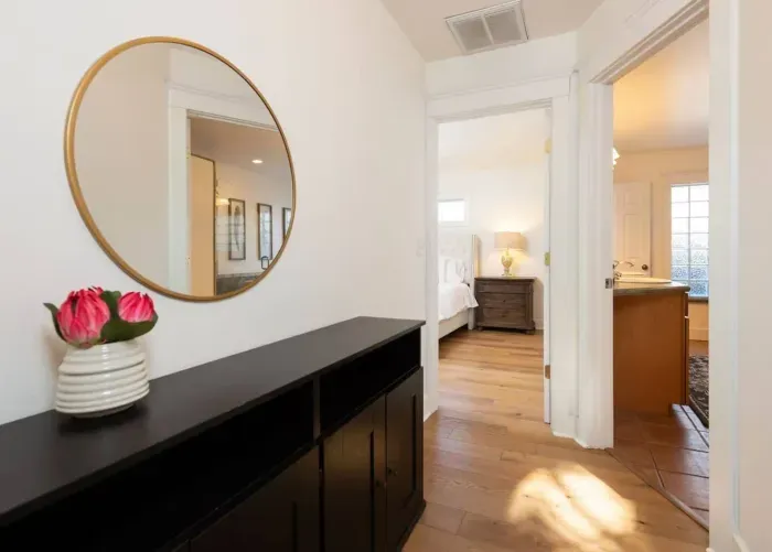 Hallway in main home to primary shared bath