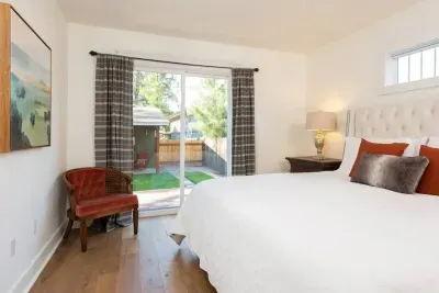 Primary room with large shared primary ensuite bathroom and access to back deck