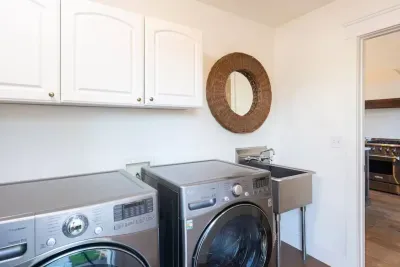 Laundryroom near kitchen leads to backyard and guest house. Free for guest use, includes detergent.