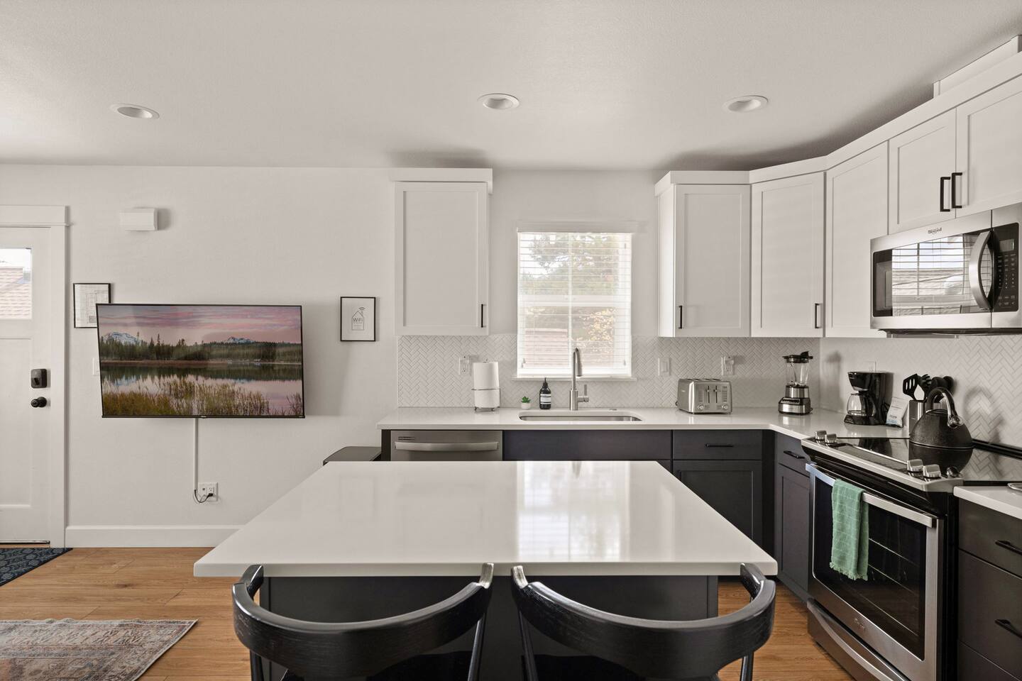 Bright modern kitchen with large island seating and stainless appliances