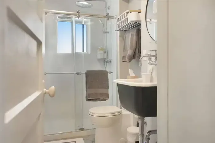 Bright modern bathroom with glass shower and natural light